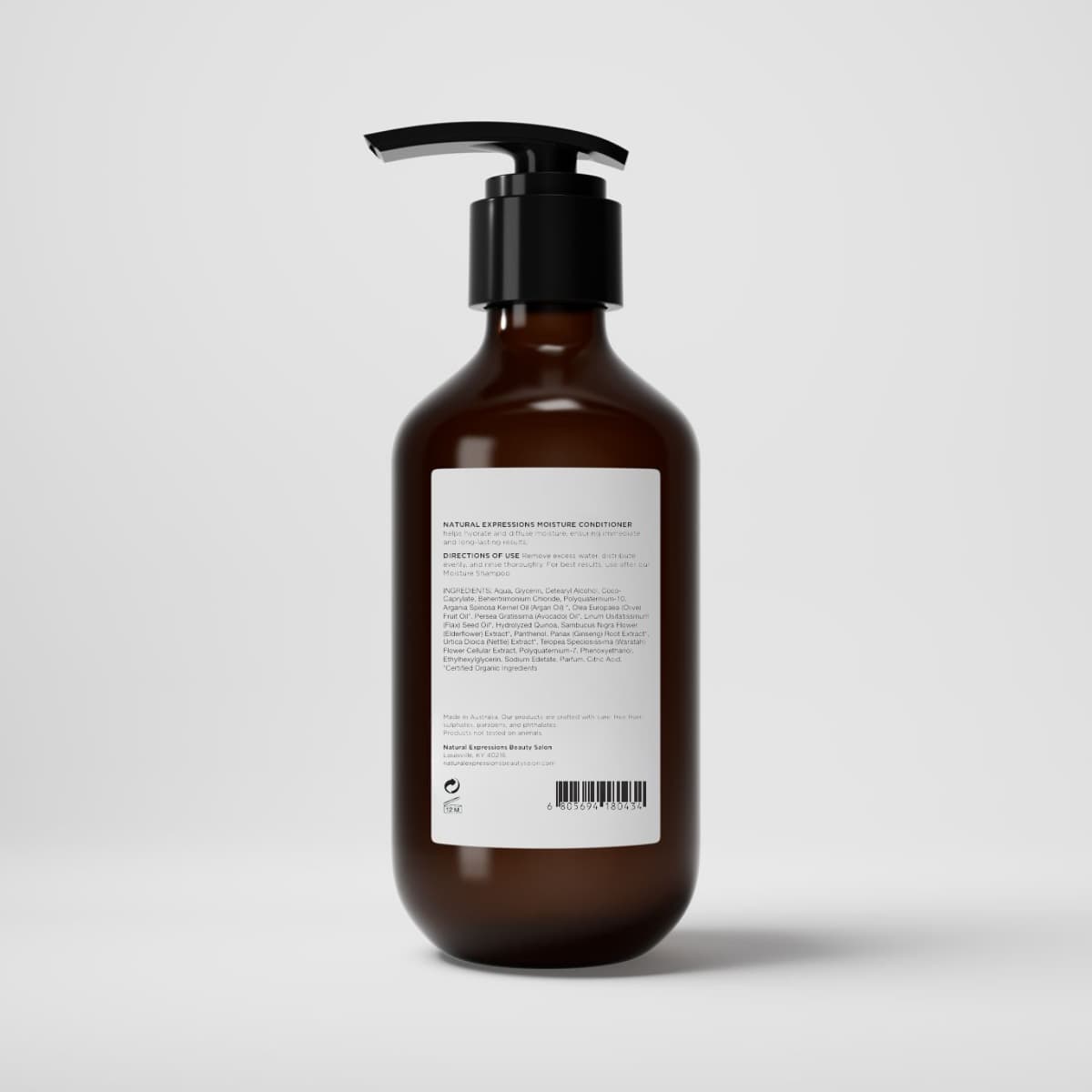 Brown bottle with pump and white label on a light gray background